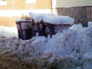 Trash cans with snow piled on them